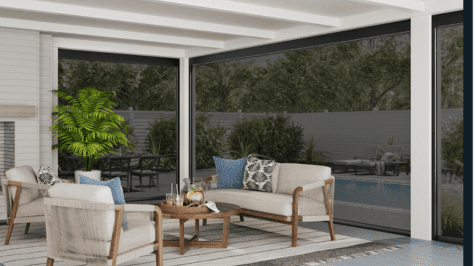 A cozy outdoor seating area with cushioned chairs and a coffee table under a pergola.