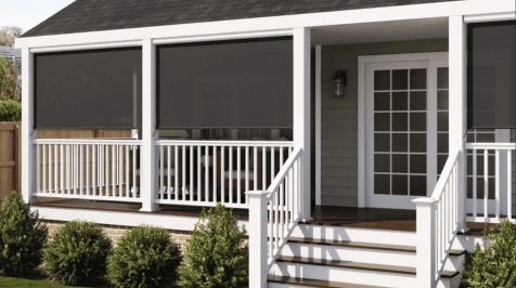 A porch with white railings and stairs leading up to a door.