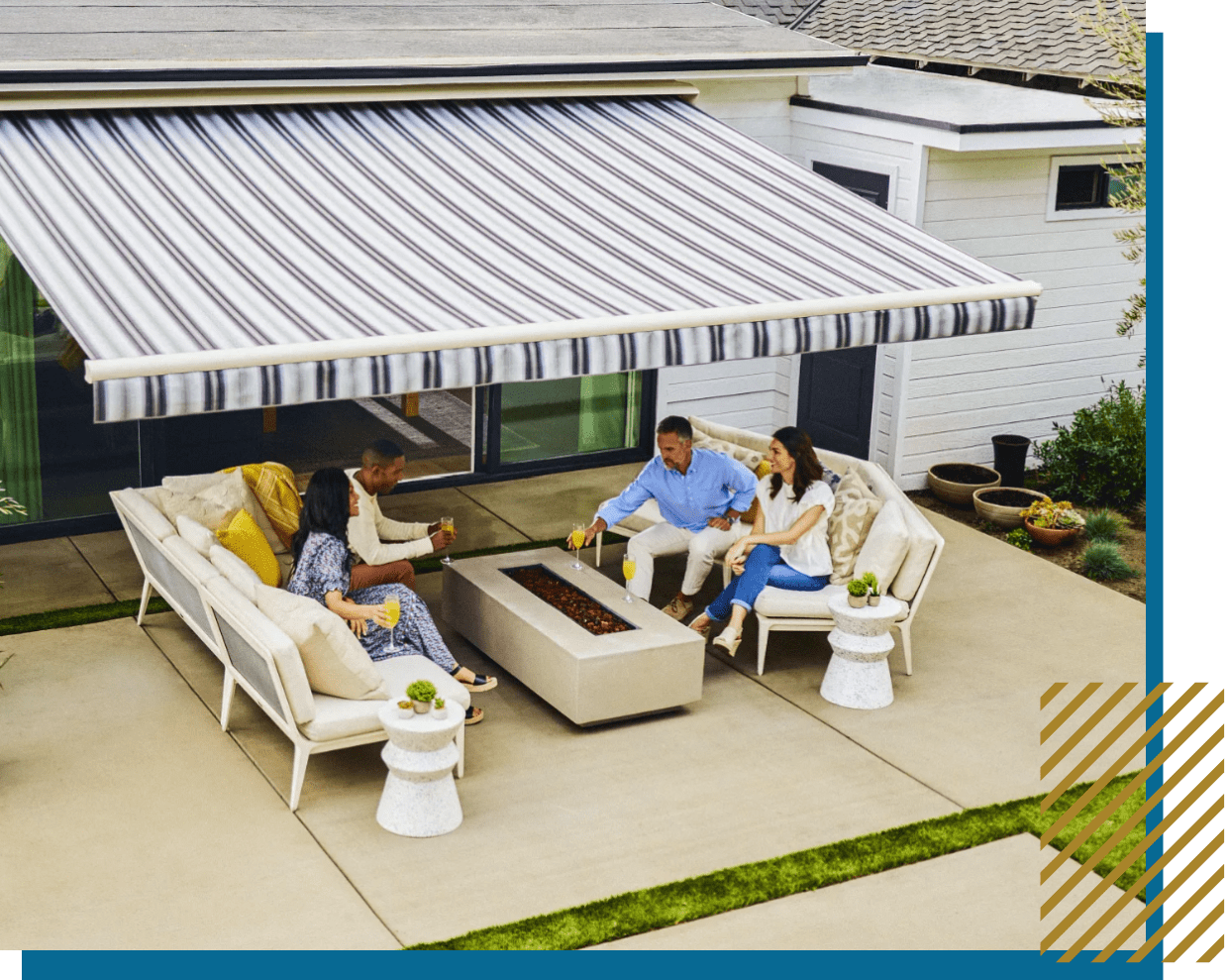 Four people sitting on patio furniture under a striped awning.