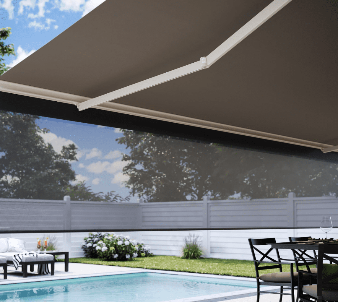 A backyard patio with a retractable awning over a swimming pool area.